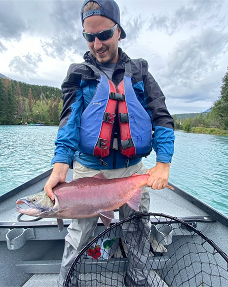Guy holding a salmon caught in the Kenai River
