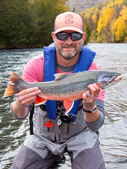 Gentleman holding a fish caught in the kenai river